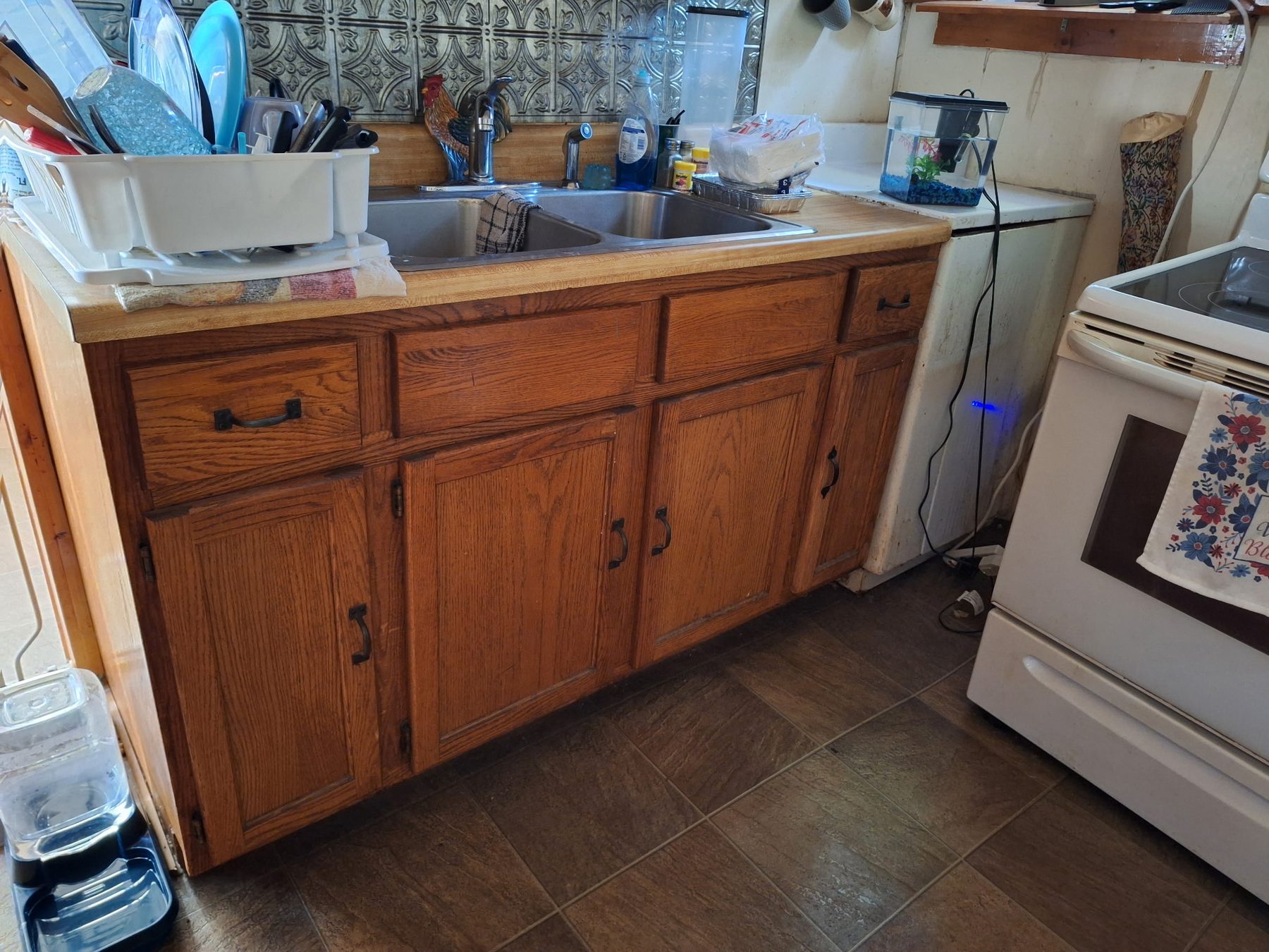 Before — stained kitchen tile, grout holding dirt.