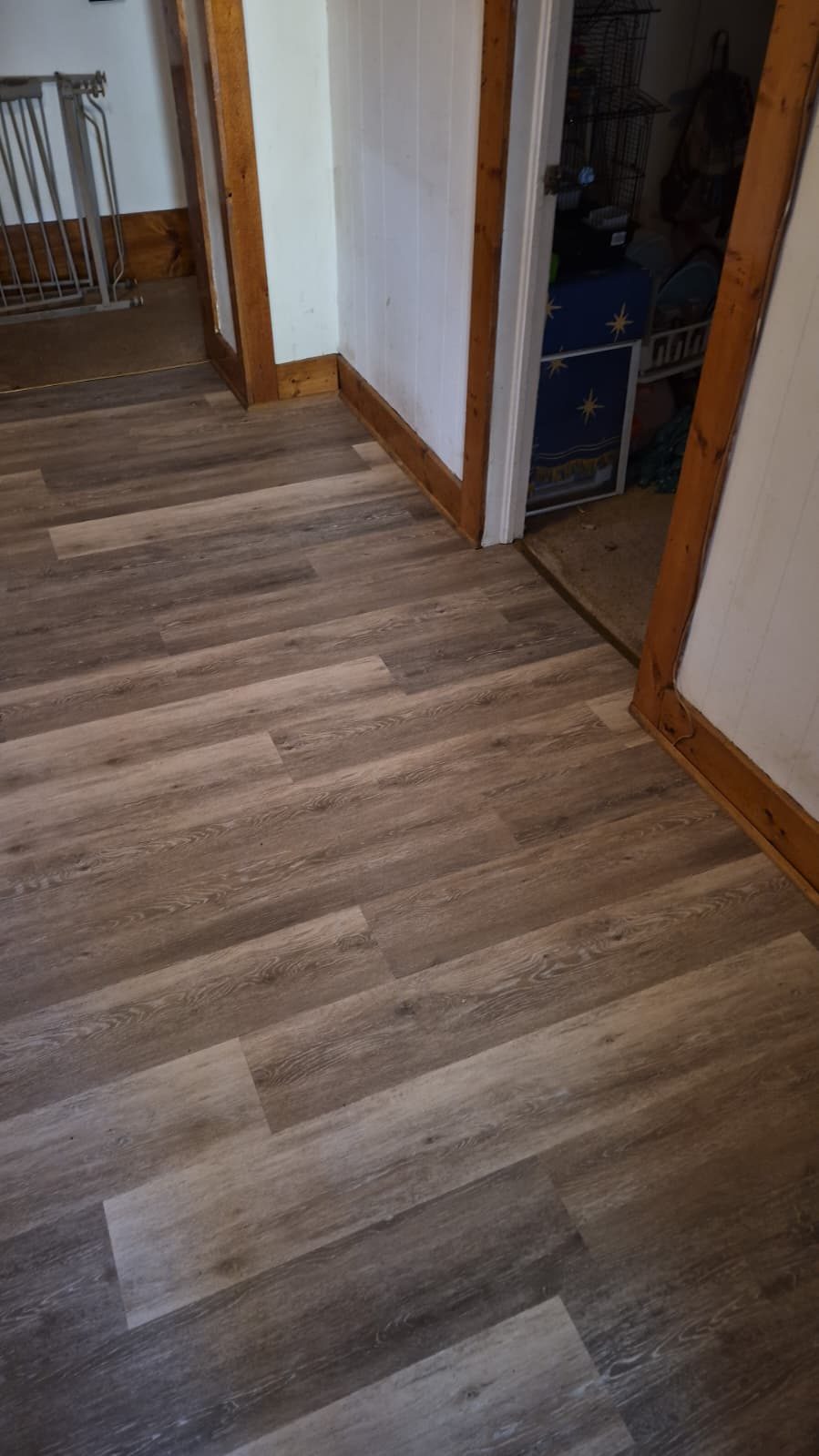 Waterproof oak-look luxury vinyl plank running through a hall