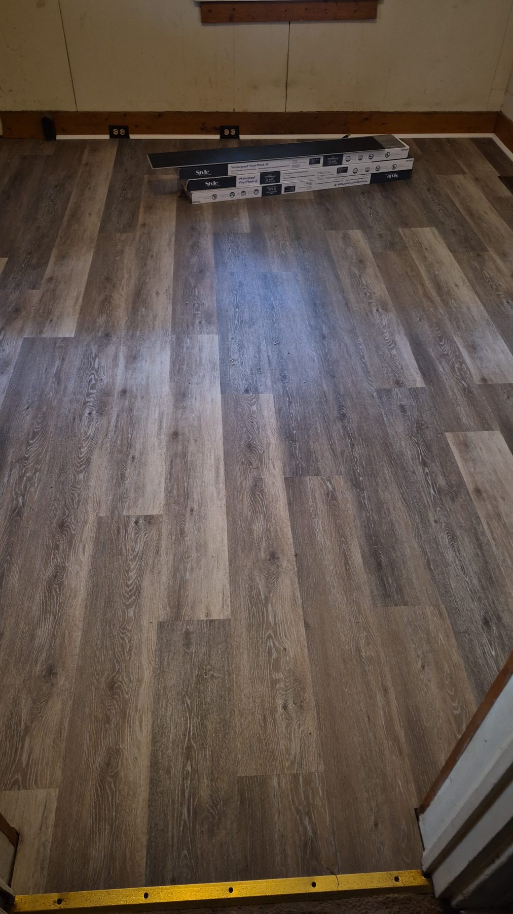 Style waterproof vinyl plank. Expansion left at the walls.